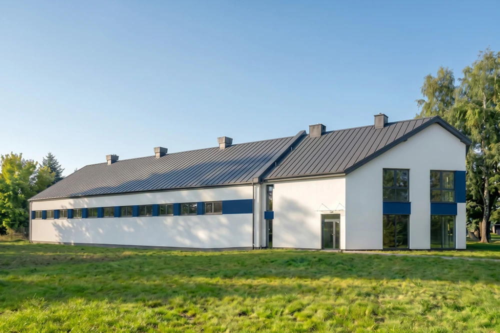Projekt budynku biurowo - magazynowego K-175, dwukondygnacyjny budynek biurowy, jednokondygnacyjna hala magazynowa - wizualizacja elewacji lewej